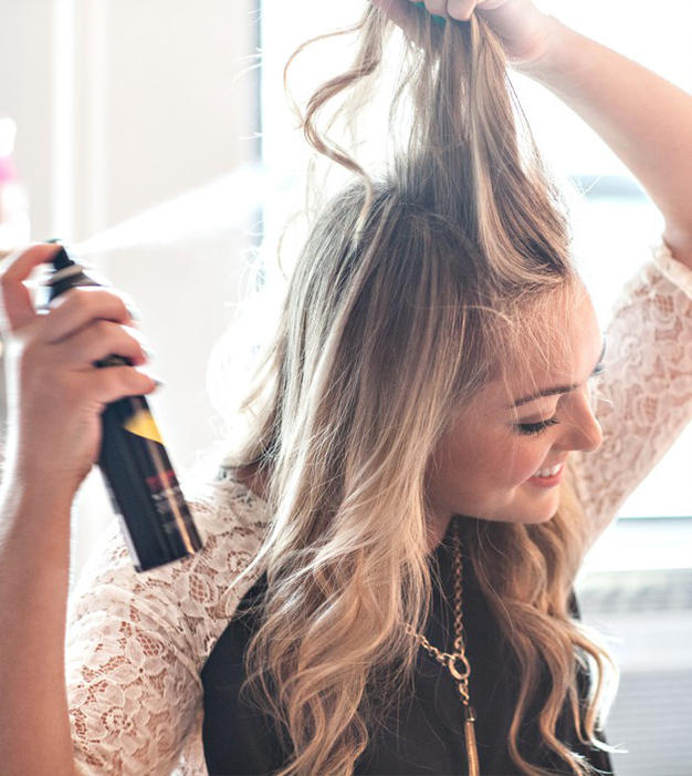 woman spraying hair