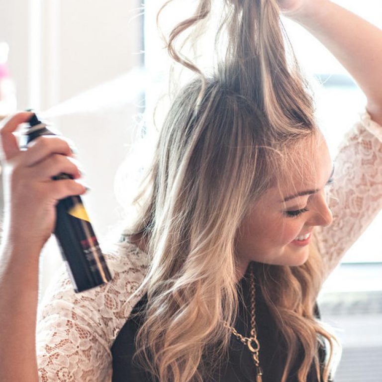woman spraying hair